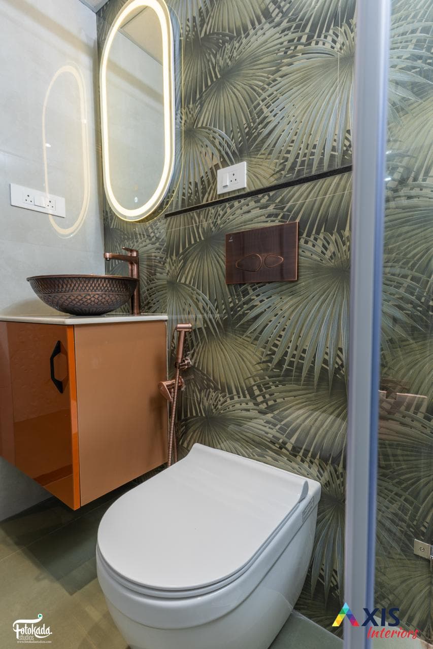 Tropical-themed washroom with copper basin and backlit mirrors